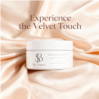 Sb Charm Velvet Body Cream with an orchid on a marble surface with greenery in the background